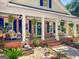 Inviting front porch with comfortable seating, hanging plants, and stylish decor at 401 Riverwalk, Mcdonough, GA 30252