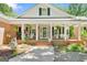 Charming front porch featuring hanging plants and comfortable seating arrangements at 401 Riverwalk, Mcdonough, GA 30252