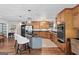 Updated kitchen features custom wood cabinets, stainless appliances, and a granite island at 401 Riverwalk, Mcdonough, GA 30252