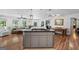 Open concept kitchen features a granite island and stainless appliances at 401 Riverwalk, Mcdonough, GA 30252