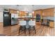 Updated kitchen features custom wood cabinets, stainless appliances, and a granite island at 401 Riverwalk, Mcdonough, GA 30252