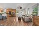 Open concept living room features hardwood floors, plenty of natural light, and access to the kitchen at 401 Riverwalk, Mcdonough, GA 30252