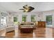 Comfortable living room features large windows, hardwood floors, and neutral-toned furnishings at 401 Riverwalk, Mcdonough, GA 30252