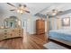 Spacious main bedroom with hardwood floors, ceiling fan, and ensuite bathroom at 401 Riverwalk, Mcdonough, GA 30252