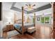 The main bedroom features a four-poster bed, tray ceilings, and lots of light at 401 Riverwalk, Mcdonough, GA 30252