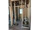 Unfinished bathroom with exposed studs, plumbing, and bathtub installation at 908 Emory St, Oxford, GA 30054