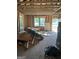 Spacious room with exposed ceiling rafters and wall studs with windows at 908 Emory St, Oxford, GA 30054