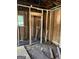 Interior view with exposed studs, electrical wiring, and plumbing at 908 Emory St, Oxford, GA 30054