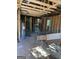 Unfinished interior with exposed framing, window and hot water heater at 908 Emory St, Oxford, GA 30054