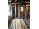 Unfinished interior with exposed studs, electrical wiring, and new windows at 908 Emory St, Oxford, GA 30054