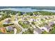 Stunning aerial view of the neighborhood showcasing beautifully landscaped homes and serene lake, offering a peaceful setting at 1516 Winward Dr, Locust Grove, GA 30248