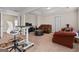 A spacious basement features a seating area with a couch and a nearby desk at 1516 Winward Dr, Locust Grove, GA 30248