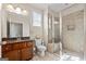 Bathroom with granite vanity, toilet, and glass-enclosed shower with tile surround at 1516 Winward Dr, Locust Grove, GA 30248