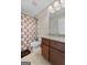 Well-lit bathroom with a granite vanity and a decorative shower curtain at 1516 Winward Dr, Locust Grove, GA 30248