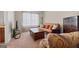 Cozy bedroom featuring a futon, soft carpet, and natural light from the window at 1516 Winward Dr, Locust Grove, GA 30248