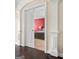 View of a bedroom with neutral walls and a red accent wall, seen through a doorway with white trim at 1516 Winward Dr, Locust Grove, GA 30248