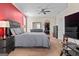 Spacious bedroom features carpet, ceiling fan, gray furniture, closet, and television at 1516 Winward Dr, Locust Grove, GA 30248