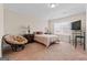 Bedroom with neutral walls, natural light and seating at 1516 Winward Dr, Locust Grove, GA 30248