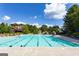 Large community pool on a sunny day surrounded by lounge chairs and umbrellas, inviting relaxation and recreation at 1516 Winward Dr, Locust Grove, GA 30248