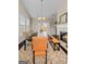 Bright dining room featuring hardwood floors, a fireplace, neutral paint and views of the backyard at 1516 Winward Dr, Locust Grove, GA 30248