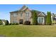 Stunning brick home with a meticulously manicured lawn and lush landscaping, exudes curb appeal and timeless elegance at 1516 Winward Dr, Locust Grove, GA 30248