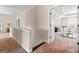 Hallway with carpet, neutral walls, white trim, and a doorway to a room at 1516 Winward Dr, Locust Grove, GA 30248