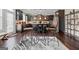Eat-in kitchen featuring dark cabinets, stainless steel appliances, hardwood floors, and an open layout at 1516 Winward Dr, Locust Grove, GA 30248