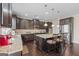 Beautiful kitchen with granite countertops, dark cabinets, stainless steel appliances, and hardwood floors at 1516 Winward Dr, Locust Grove, GA 30248