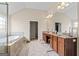 The en suite main bathroom features a double vanity, large mirror, and separate tub at 1516 Winward Dr, Locust Grove, GA 30248