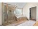 Large bathroom features a glass-door shower, and a large soaking tub with tile surround at 1516 Winward Dr, Locust Grove, GA 30248