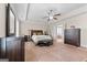 Main bedroom with neutral paint, crown molding, ceiling fan, lots of space, and hardwood dressers at 1516 Winward Dr, Locust Grove, GA 30248