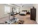 Spacious main bedroom featuring tray ceilings, a ceiling fan, lots of space, and large dressers at 1516 Winward Dr, Locust Grove, GA 30248
