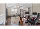 Well-lit office space with a ceiling fan, hardwood floors, and a large window overlooking the front yard at 1516 Winward Dr, Locust Grove, GA 30248