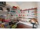 Walk-in pantry features wood floors, white wire shelving, and ample storage space for food and kitchen items at 1516 Winward Dr, Locust Grove, GA 30248