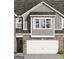 Exterior facade showing the garage, brick, siding, and windows at 2032 Piccolo Ct # 226, Mcdonough, GA 30252