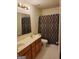 Bathroom with a dual sink vanity, matching light fixtures, and a framed mirror at 690 Gateway Ct, Stone Mountain, GA 30087