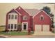 Classic two-story brick home with attached garage and well-manicured lawn, a picture of suburban charm at 690 Gateway Ct, Stone Mountain, GA 30087