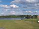 Scenic view of a lush golf course with a serene lake and picturesque homes in the background at 690 Gateway Ct, Stone Mountain, GA 30087