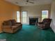 Cozy living room featuring a fireplace with mantle, neutral wall paint, and bright windows at 690 Gateway Ct, Stone Mountain, GA 30087