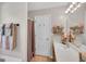 Bright bathroom with a bathtub, light fixture and a mirror above the sink at 2006 Carrollton Hwy, Temple, GA 30179