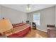 This inviting bedroom features hardwood floors, a ceiling fan and a comfortable bed next to a window at 2006 Carrollton Hwy, Temple, GA 30179