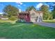 Charming two-story home with a red front door, inviting porch, and well-maintained lawn and mature trees at 2006 Carrollton Hwy, Temple, GA 30179