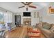 Cozy living room showcasing a stone fireplace, hardwood floors, and a ceiling fan at 2006 Carrollton Hwy, Temple, GA 30179