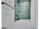 Bathroom featuring stylish green tile, a shower and tub, and matte black fixtures at 152 Dana Dr, Fayetteville, GA 30215