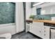 Stylish bathroom boasts a tiled shower/tub, wooden countertop, and modern fixtures at 152 Dana Dr, Fayetteville, GA 30215