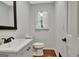 Clean and bright bathroom featuring a vanity, toilet, and a window offering natural light at 152 Dana Dr, Fayetteville, GA 30215