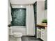 Modern bathroom featuring stylish green subway tiles, a shower-tub combo, and a vanity with wooden countertop at 152 Dana Dr, Fayetteville, GA 30215