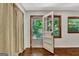 Bedroom featuring hardwood floors, curtained wall, exterior access, and natural light from multiple windows at 152 Dana Dr, Fayetteville, GA 30215