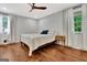 Cozy bedroom with wood floors, neutral walls, and two windows with curtains at 152 Dana Dr, Fayetteville, GA 30215