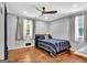 Comfortable bedroom with hardwood floors, ceiling fan, and natural light through the windows at 152 Dana Dr, Fayetteville, GA 30215